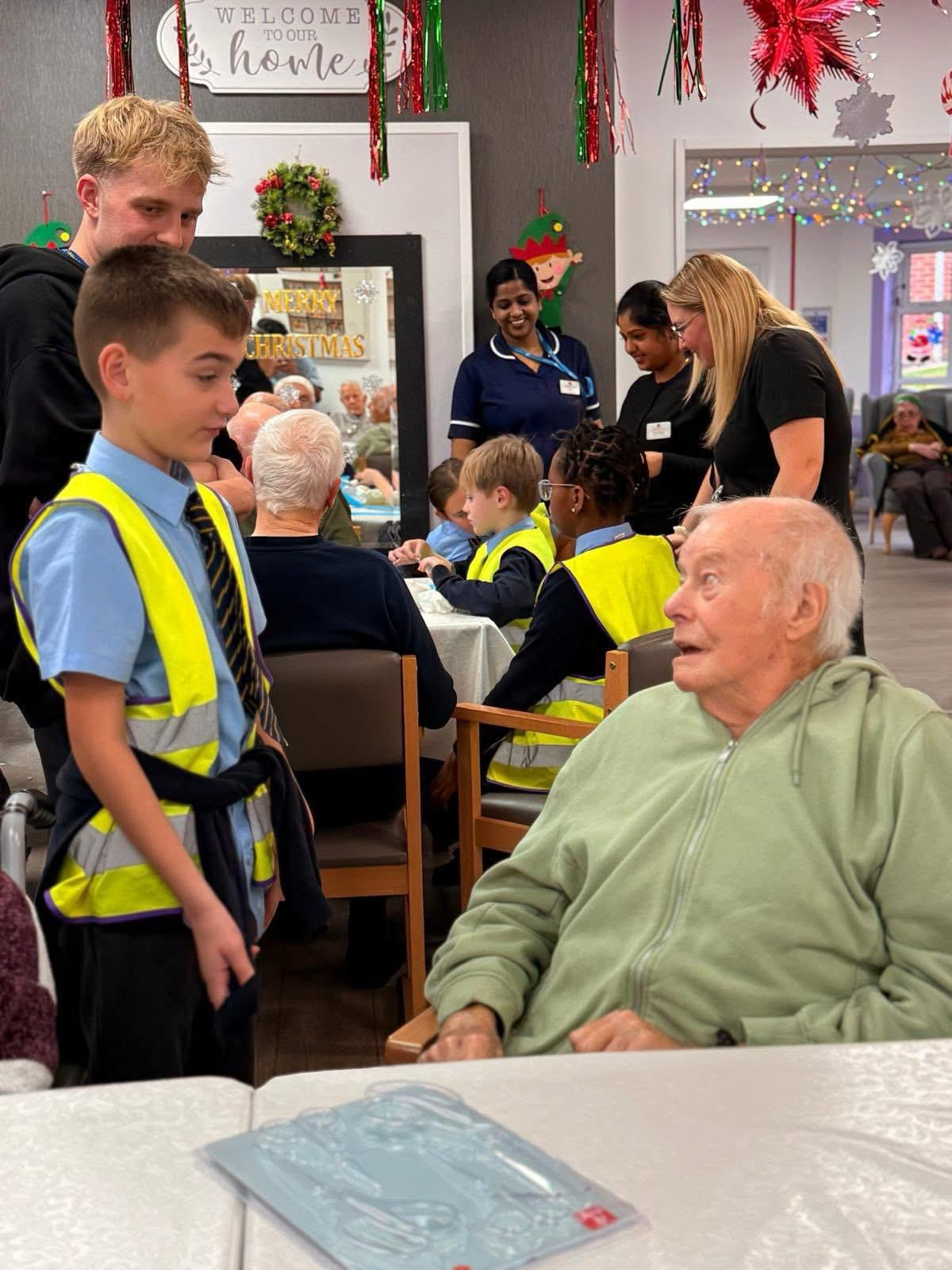 St Boniface pupils speaking with residents during a care-home visit
