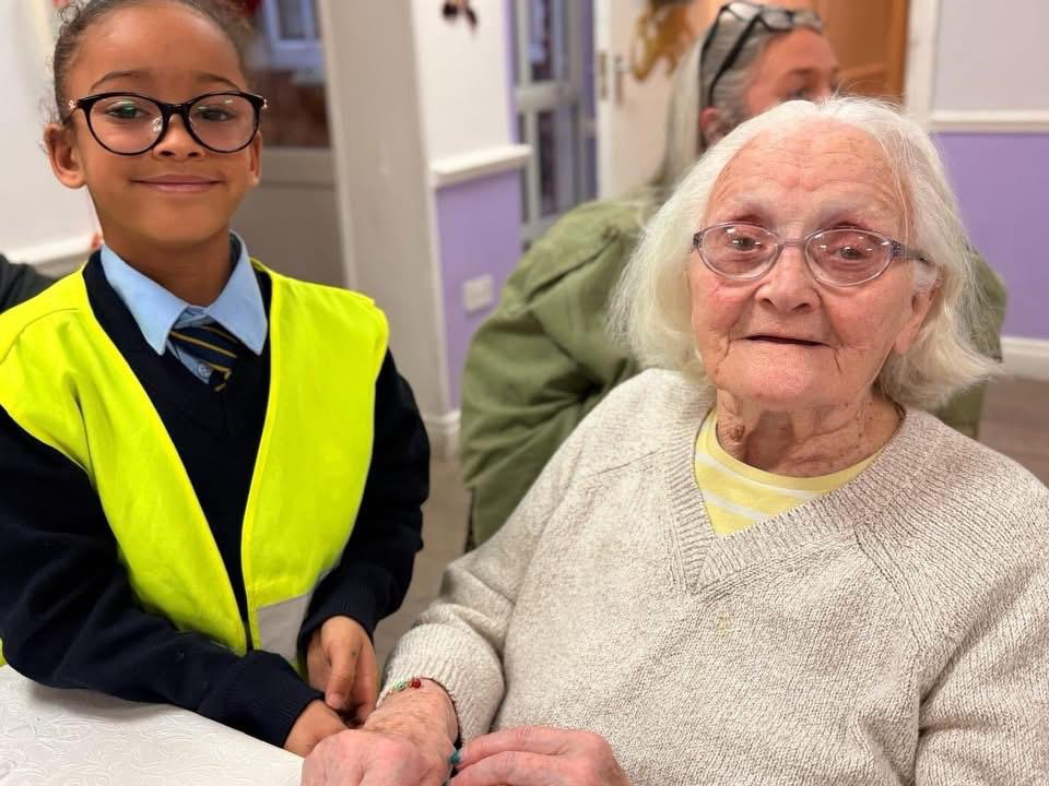 A St Boniface pupil sharing time with a care-home resident